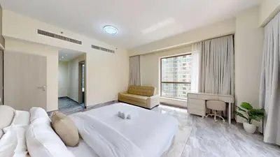 a bedroom with a large white bed and a window at Rimal - Upgraded Three Plus Kids Bedroom in JBR in Dubai