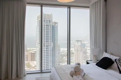 a bedroom with a view of a tall building at Royal suites LIv Marina views in Dubai