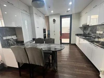 a kitchen with a table and chairs in a room at Room for rent in a luxury villa in Dubai