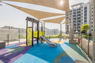 a playground on the roof of a building at Close to Meydan Racecourse and Ras Al Khor Wildlife Sanctuary, And a Quick Drive to Downtown Dubai and the Iconic Burj Khalifa - Azizi Riviera 44, Meydan by Deluxe Holiday Homes in Dubai