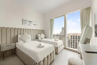 a hotel room with two beds and a large window at VayK - Stunning 2BR Apt with 2 Balconies in Downtown in Dubai