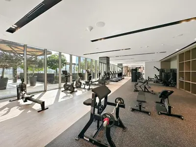 a gym with a lot of treadmills and exercise bikes at VayK - Stunning 2BR Apt with 2 Balconies in Downtown in Dubai