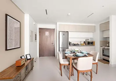a kitchen and dining room with a table and chairs at Elegant 1BHK Dubai Private Beachfront in Dubai