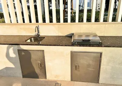 a kitchen with a sink and a counter top at Elegant 1BHK Dubai Private Beachfront in Dubai