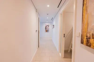 a hallway with white walls and a tile floor at Magical La Vie JBR Apt with Private Beach Access in Dubai