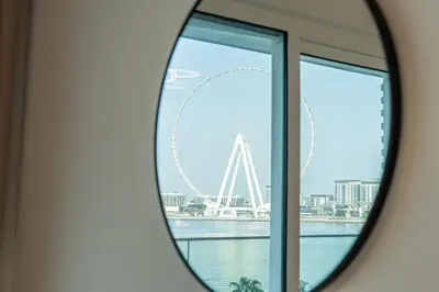a mirror reflecting a view of the london eye at Magical La Vie JBR Apt with Private Beach Access in Dubai