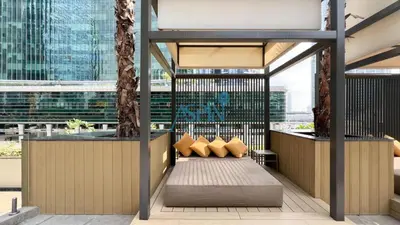 a seating area in a building with pillows at Aspin Modern Studio Apartment in AHAD Residency in Dubai