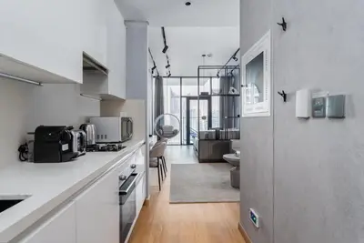 a kitchen with white countertops and a large window at GuestReady - Canal View Studio | Near Downtown in Dubai