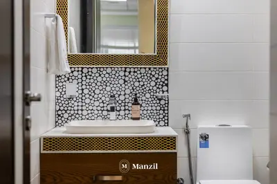 a bathroom with a sink and a mirror at Luxury 2BR Apartment in Business Bay with Pool, Sauna and Burj Khalifa View in Dubai