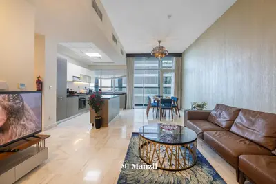 a living room with a couch and a table at Luxury 2BR Apartment in Business Bay with Pool, Sauna and Burj Khalifa View in Dubai