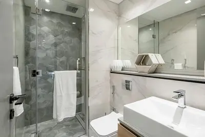 a bathroom with a shower and a toilet and a sink at FAM Living - Urban Stays - MAG318, 5 mins to Burj Khalifa in Dubai