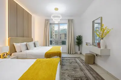 a hotel room with two beds and a window at Serene 2BR Burj Khalifa & Fountain View in Dubai