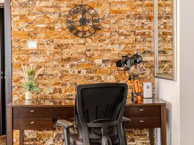 an office with a brick wall and a desk and a chair at Luxury in Dubai Marina 1BR beside Vida Yacht Club in Dubai