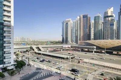 a city with a busy street with cars and buildings at Cozy 1BR Apartment in Dubai Marina with City Views in Dubai