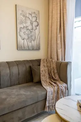 a brown couch in a living room with a window at Airstay - Cozy 1BR - Canal View - Business Bay - Monthly Offer Available in Dubai