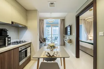 a kitchen with a table and a dining room at Airstay - Cozy 1BR - Canal View - Business Bay - Monthly Offer Available in Dubai