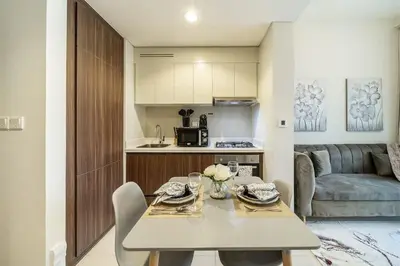 a kitchen and living room with a table and chairs at Airstay - Cozy 1BR - Canal View - Business Bay - Monthly Offer Available in Dubai