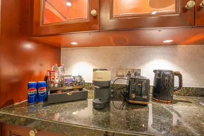 a kitchen with a counter top with a coffee maker at Zaafaran 5 Full Burj View Downtown Luxury Stay in Dubai