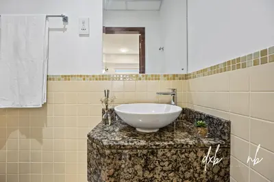 a bathroom with a white bowl sink on a counter at Pistachio Pecan - Sea View - Luxury 1 BR Apartment at JBR Beach in Dubai