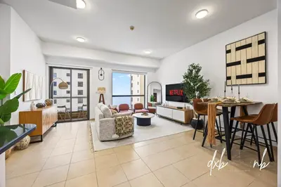 a living room with a couch and a table at Pistachio Pecan - Sea View - Luxury 1 BR Apartment at JBR Beach in Dubai