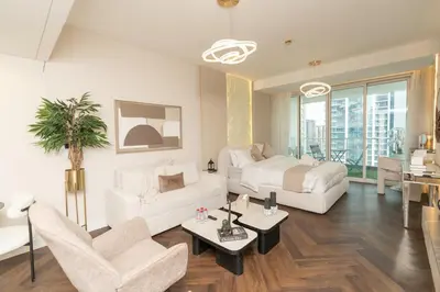 a living room with a bed and a couch at JLT Laguna Tower Spacious Studio with Lake View for 4 Guests in Dubai