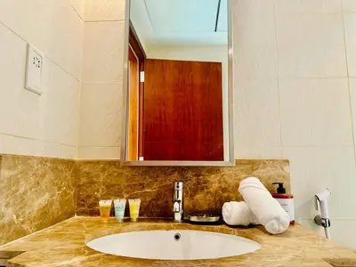 a bathroom with a sink and a mirror at Modern Apartment standpoint near dubai opera in Dubai
