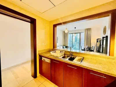 a kitchen with a sink and a large mirror at Modern Apartment standpoint near dubai opera in Dubai