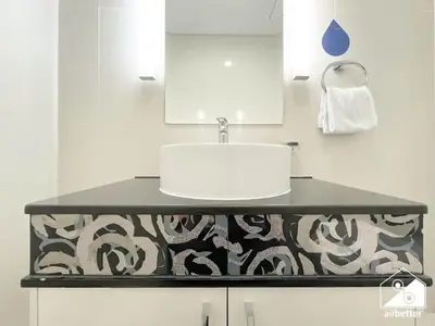 a bathroom with a sink and a white counter at Elegant 2-Bed Retreat, Stunning Downtown Views in Dubai