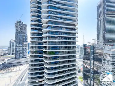a tall building in a city with tall buildings at Elegant 2-Bed Retreat, Stunning Downtown Views in Dubai