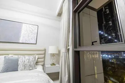 a bedroom with a bed and a large mirror at Luxury Apartment - Downtown in Dubai