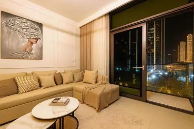 a living room with a couch and a large window at Luxury Apartment - Downtown in Dubai