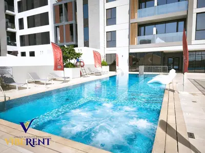 a swimming pool in the middle of a building at Modern 6 sleeper JVC Rooftop pool, tennis court 10 min to Marina in Dubai