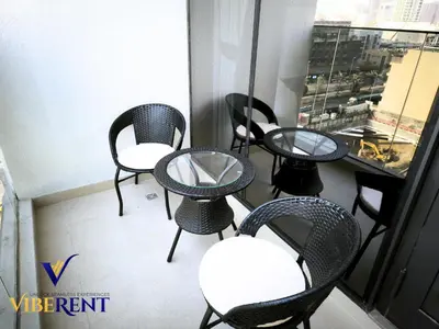 a group of chairs and tables on a balcony at Modern 6 sleeper JVC Rooftop pool, tennis court 10 min to Marina in Dubai
