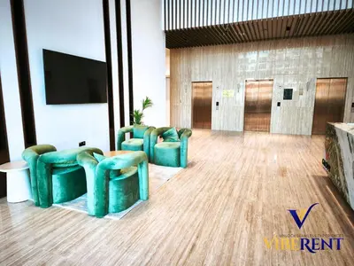 a room with three chairs and a flat screen tv at Modern 6 sleeper JVC Rooftop pool, tennis court 10 min to Marina in Dubai