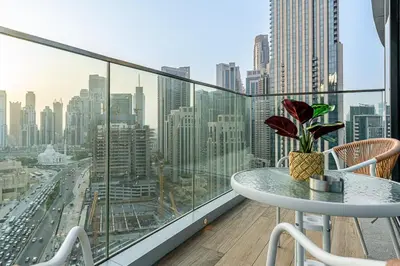 a balcony with a table and a view of a city at Deluxe, Elegant - 3BR - DT - Burj Khalifa View in Dubai