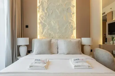 a bedroom with a white bed with two towels on it at New Studio Aura JVC Pool Gym Sauna Padel court in Dubai