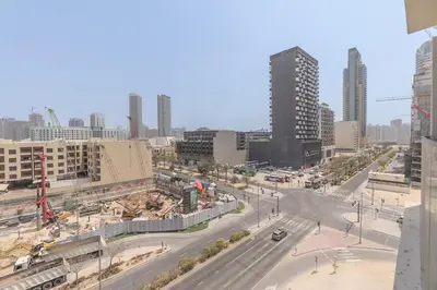 an aerial view of a city with buildings and a street at New Studio Aura JVC Pool Gym Sauna Padel court in Dubai