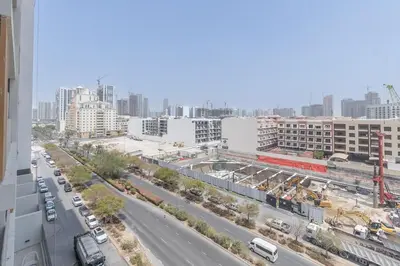 an aerial view of a city street with buildings at New Studio Aura JVC Pool Gym Sauna Padel court in Dubai