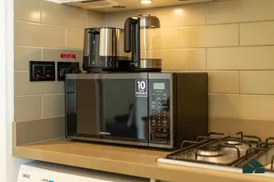 a microwave oven sitting on top of a counter at Cozy 1BR for 3 with Community View by BMS in Dubai