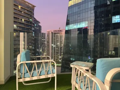 a balcony with two chairs and a view of a city at Infinity Pool - 6 minutes to Dubai Mall - Luxury in Dubai