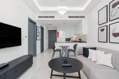 a living room with a couch and a table at Stylish Living with a Cozy Touch in Dubai