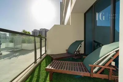a balcony with two chairs and a bench on a building at Stylish Living with a Cozy Touch in Dubai