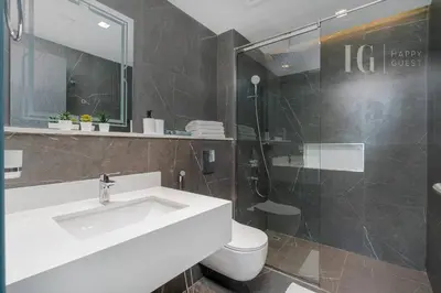 a bathroom with a sink and a toilet and a shower at Stylish Living with a Cozy Touch in Dubai