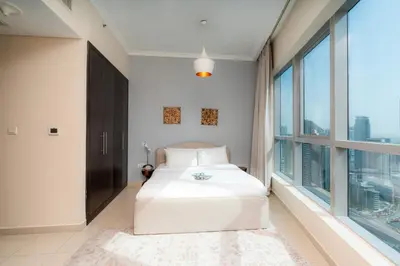 a bedroom with a bed and a large window at Great Location - Stunning Views - Scenic in Dubai