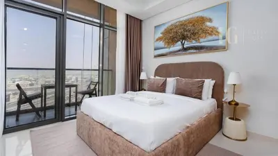 a bedroom with a bed and a large window at Charming Studio with Cozy Vibes in Dubai