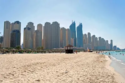 a beach in front of a city with tall buildings at Hospitality Expert Rimal 5BR Marina Beach Pool in Dubai
