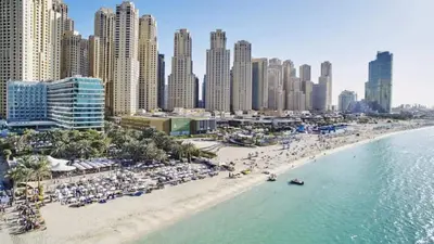 an aerial view of a beach in front of a city at Hospitality Expert Rimal 5BR Marina Beach Pool in Dubai