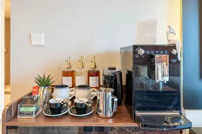 a counter with a coffee maker and a microwave at Designer 1 Bedroom Apartments in Dubai Hills Estate in Dubai