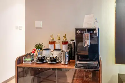 a counter with a coffee maker and a microwave at Designer 1 Bedroom Apartments in Dubai Hills Estate in Dubai