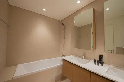 a bathroom with a tub and a sink and a mirror at Rosewater at Creek Beach Building 2 Luxury Creekside Living with Beach & Pool Access in Dubai